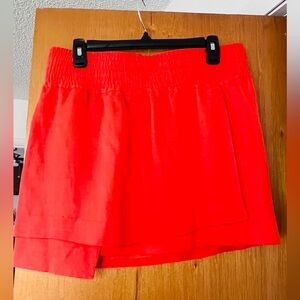 Acne Studios orange skirt. Asymmetrical layered material.